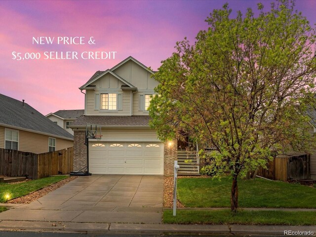 4436 Windmill Dr, Brighton, CO 80601 - view of front of house featuring an attached garage, board and batten siding, concrete driveway, and brick siding