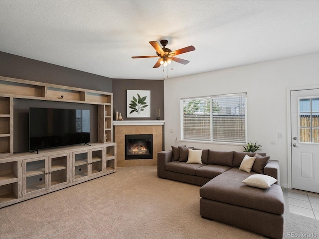 4436 Windmill Dr, Brighton, CO 80601 - living area featuring ceiling fan, a tiled fireplace, and carpet flooring