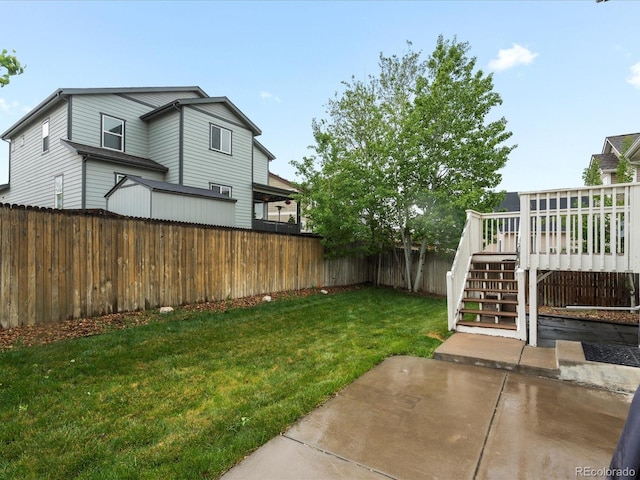 4436 Windmill Dr, Brighton, CO 80601 - fenced backyard with stairs, a patio, and a wooden deck
