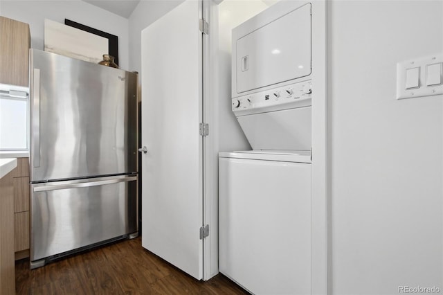 1711 Hooker St Unit 2, Denver, CO 80204 - washroom featuring stacked washing machine and dryer and dark wood finished floors