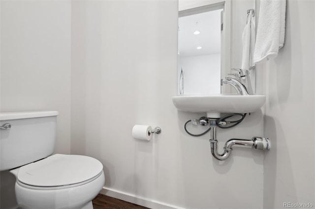 1711 Hooker St Unit 2, Denver, CO 80204 - half bath featuring toilet and wood finished floors