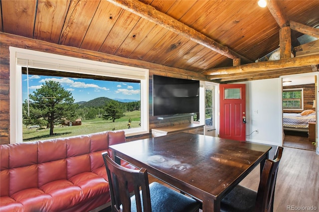 dining space with wooden ceiling, plenty of natural light, hardwood / wood-style floors, and lofted ceiling with beams