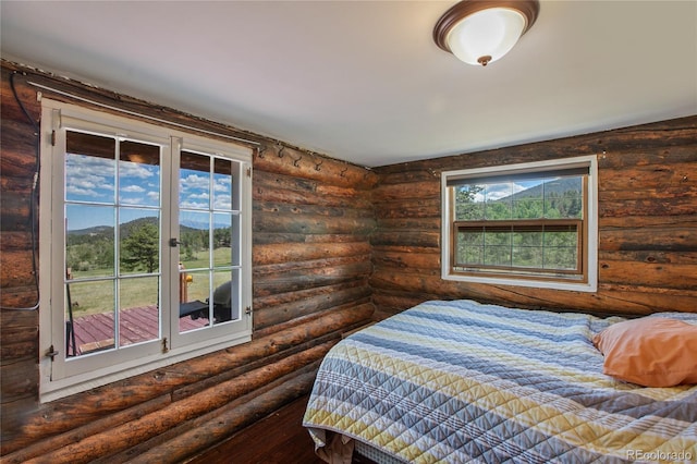 bedroom featuring hardwood / wood-style flooring and rustic walls