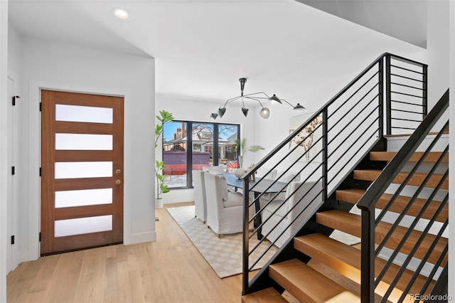 foyer featuring a notable chandelier and light hardwood / wood-style flooring