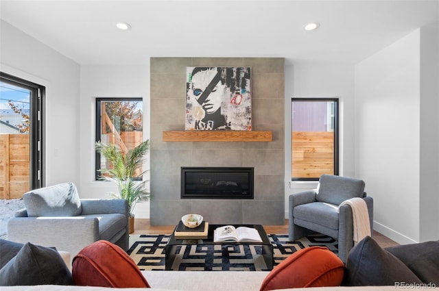 living room featuring hardwood / wood-style floors and a tiled fireplace