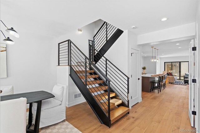 stairs featuring wood-type flooring