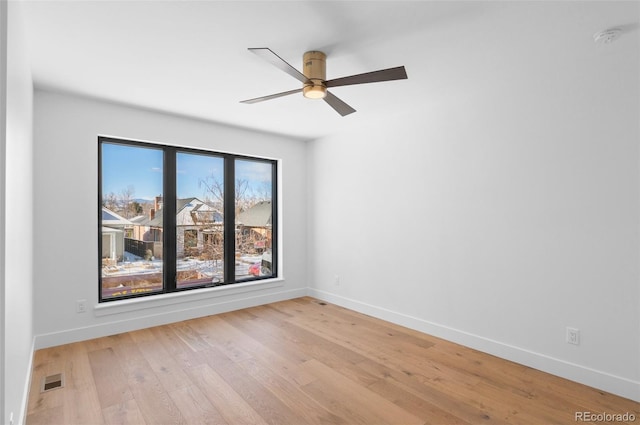 spare room with ceiling fan and light hardwood / wood-style floors