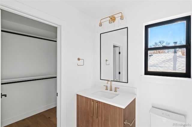 bathroom featuring hardwood / wood-style floors, vanity, and toilet