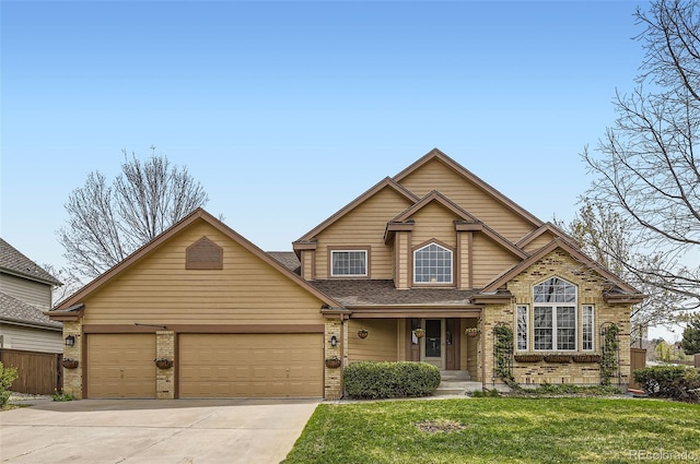 traditional-style home with brick siding, a garage, a front yard, and concrete driveway