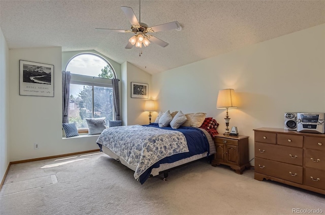 bedroom with a textured ceiling, vaulted ceiling, light carpet, and baseboards