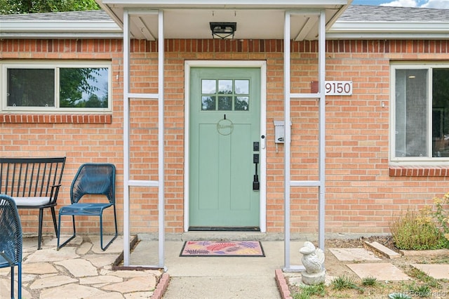 9150 Fir Dr, Thornton, CO 80229 - property entrance with brick siding and a shingled roof