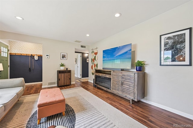 9150 Fir Dr, Thornton, CO 80229 - living area featuring wood finished floors, recessed lighting, and a glass covered fireplace