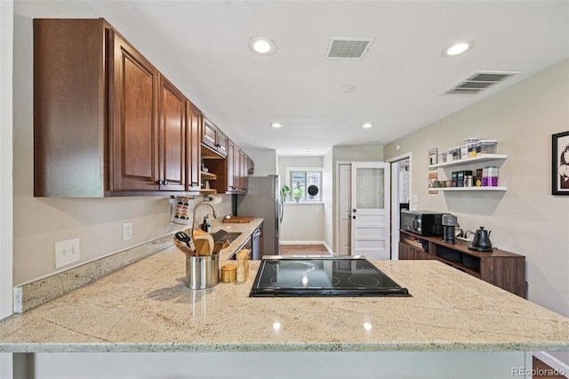 9150 Fir Dr, Thornton, CO 80229 - kitchen featuring open shelves, appliances with stainless steel finishes, recessed lighting, light stone counters, and a peninsula