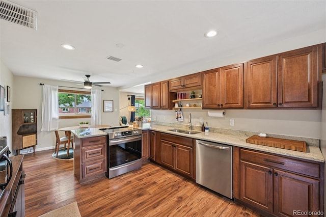 9150 Fir Dr, Thornton, CO 80229 - kitchen featuring stainless steel appliances, a peninsula, ceiling fan, dark wood-style flooring, and recessed lighting