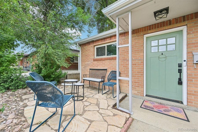 9150 Fir Dr, Thornton, CO 80229 - property entrance with brick siding and a patio area