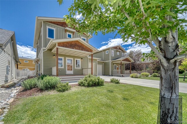 26 S Trailside Cir Unit A, Salida, CO 81201 - view of front of house with a porch, concrete driveway, board and batten siding, and a garage