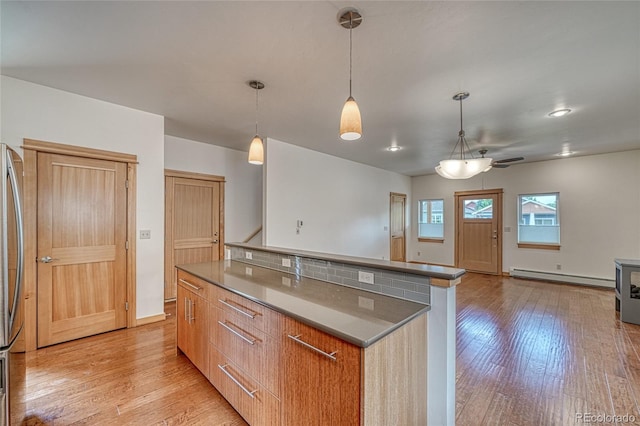26 S Trailside Cir Unit A, Salida, CO 81201 - kitchen with a baseboard radiator, light wood-type flooring, a center island, and modern cabinets