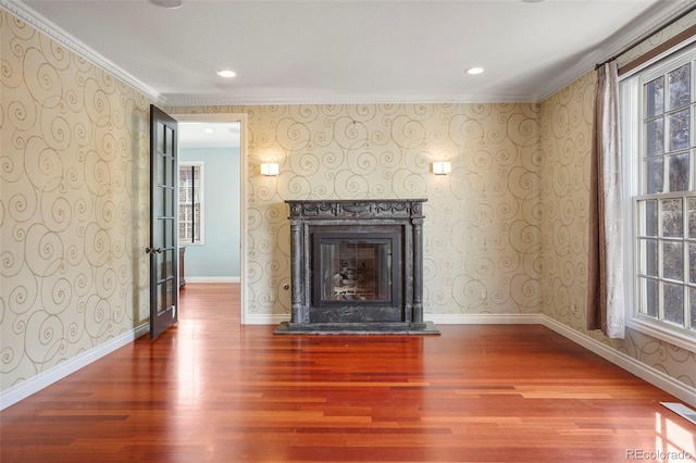 unfurnished living room with wallpapered walls and baseboards