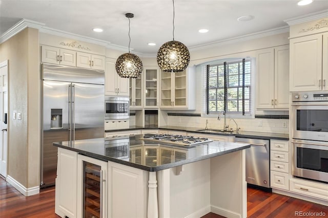 kitchen featuring wine cooler, built in appliances, dark wood-style flooring, and a sink