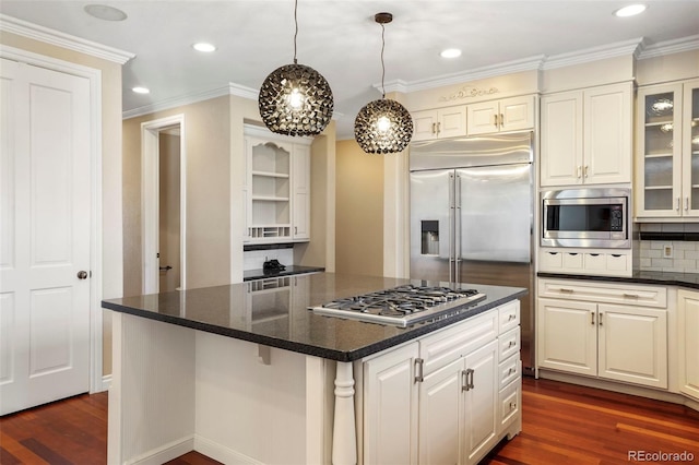 kitchen featuring tasteful backsplash, dark wood-style floors, crown molding, glass insert cabinets, and built in appliances