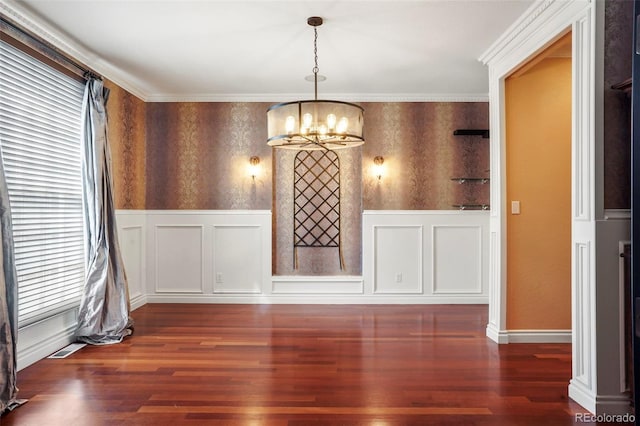 unfurnished dining area featuring wallpapered walls, wood finished floors, and a chandelier