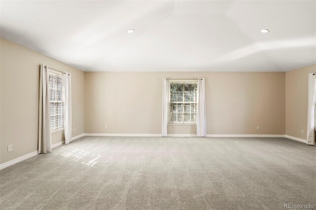 carpeted spare room with recessed lighting and baseboards