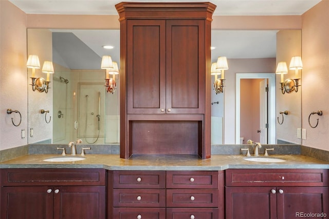 full bathroom featuring a shower stall, double vanity, and a sink