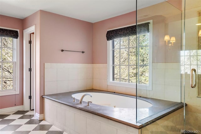 full bath with tile patterned floors, baseboards, a garden tub, and a shower stall