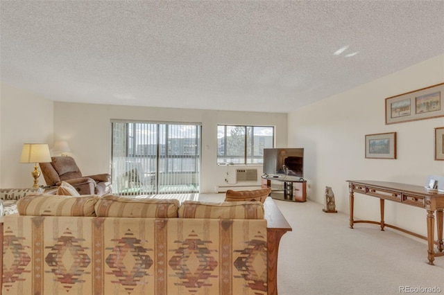 living room featuring a wall mounted AC, a textured ceiling, and carpet flooring