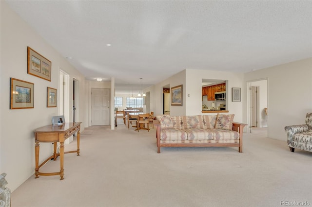 living room with light colored carpet and a textured ceiling