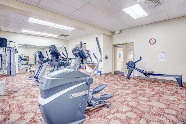 gym with carpet floors and a drop ceiling