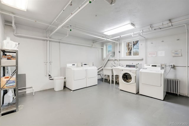 common laundry area featuring radiator and separate washer and dryer