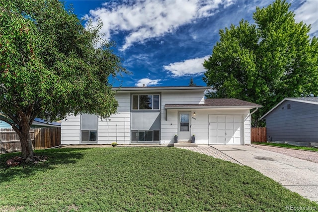 view of front of property with a garage and a front yard