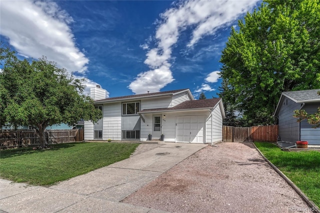 view of front of house with a garage and a front yard