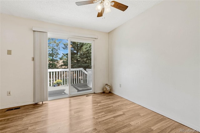 unfurnished room with ceiling fan, light hardwood / wood-style flooring, and a textured ceiling