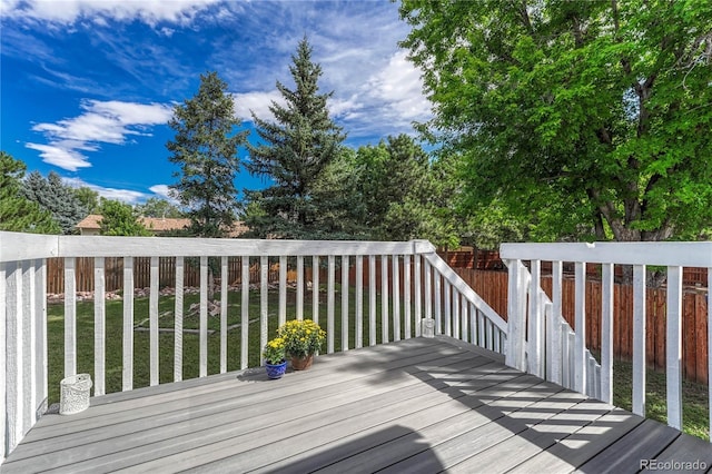 wooden deck featuring a lawn