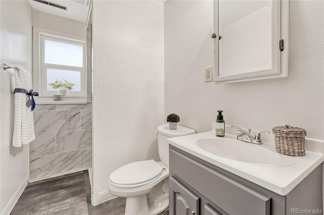 bathroom featuring vanity, toilet, and hardwood / wood-style floors