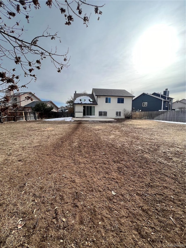 rear view of property featuring a patio area