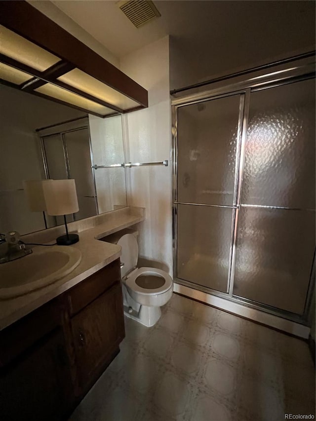 bathroom with vanity, toilet, and walk in shower