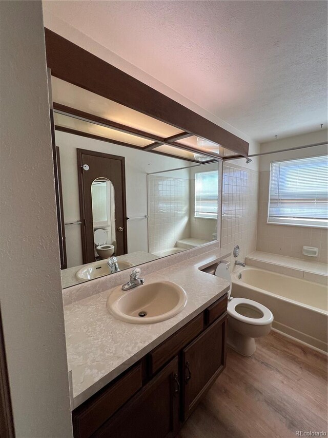 5941 S Quail Way, Littleton, CO 80127 - bathroom with wood finished floors, vanity, and a textured ceiling