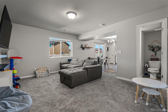 7568 Benecia Dr, Fountain, CO 80817 - living area with a chandelier, carpet flooring, baseboards, and a textured ceiling