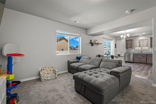7568 Benecia Dr, Fountain, CO 80817 - living room with a chandelier, carpet floors, plenty of natural light, and baseboards