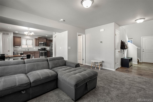 7568 Benecia Dr, Fountain, CO 80817 - living room featuring a chandelier, carpet, baseboards, and recessed lighting