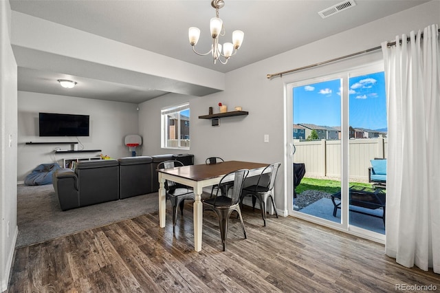 7568 Benecia Dr, Fountain, CO 80817 - dining room with wood finished floors, healthy amount of natural light, and a chandelier