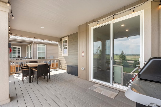 864 Clover Loop, Erie, CO 80026 - wooden deck featuring outdoor dining area