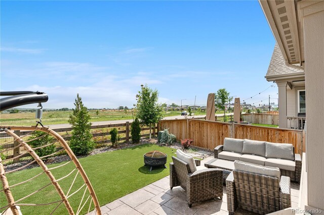 864 Clover Loop, Erie, CO 80026 - fenced backyard with an outdoor living space with a fire pit and a patio area