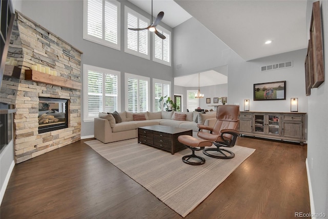877 Eldorado Dr, Superior, CO 80027 - living room with a ceiling fan, a high ceiling, wood finished floors, a stone fireplace, and baseboards