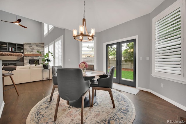 877 Eldorado Dr, Superior, CO 80027 - dining area featuring a fireplace, french doors, dark wood-style floors, and a chandelier