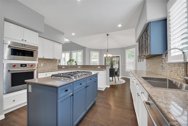 877 Eldorado Dr, Superior, CO 80027 - kitchen featuring a sink, appliances with stainless steel finishes, a chandelier, blue cabinets, and white cabinets