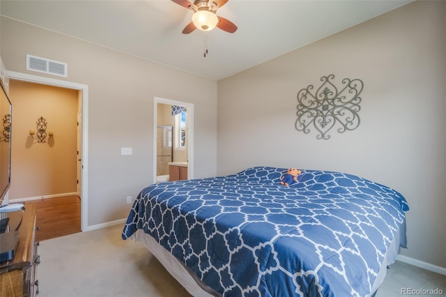 bedroom featuring carpet flooring, ensuite bathroom, and ceiling fan